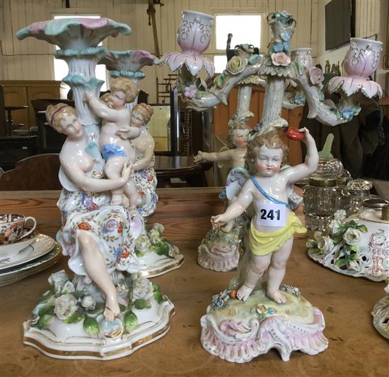 Pr German porcelain figural bon bon dishes and a pair of similar candlesticks